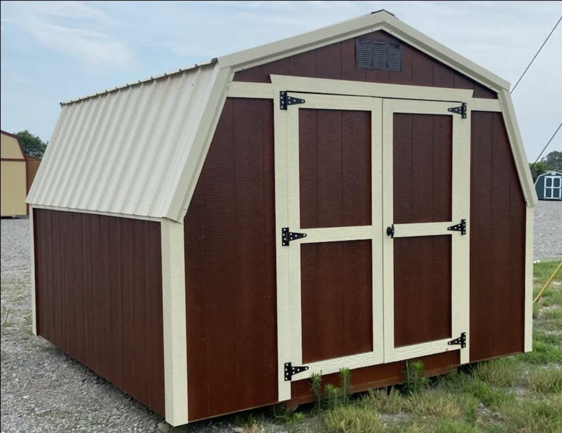 Brown barn style storage shed with cream trim and double doors