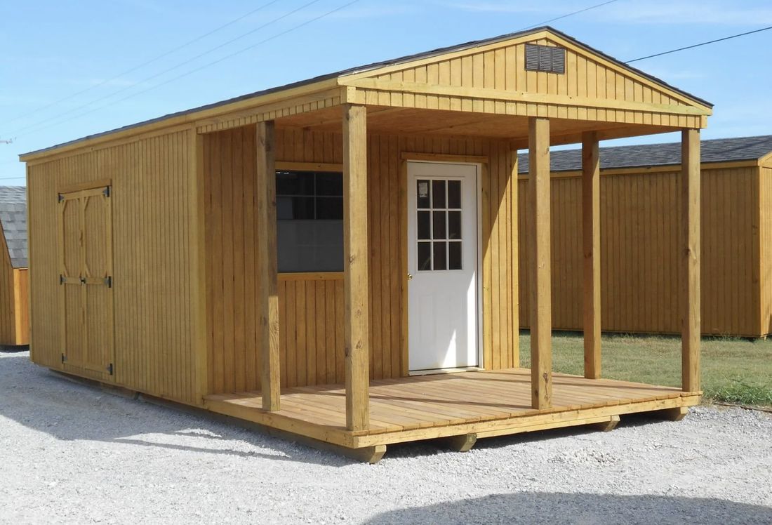 Wood portable building with a covered front porch and window